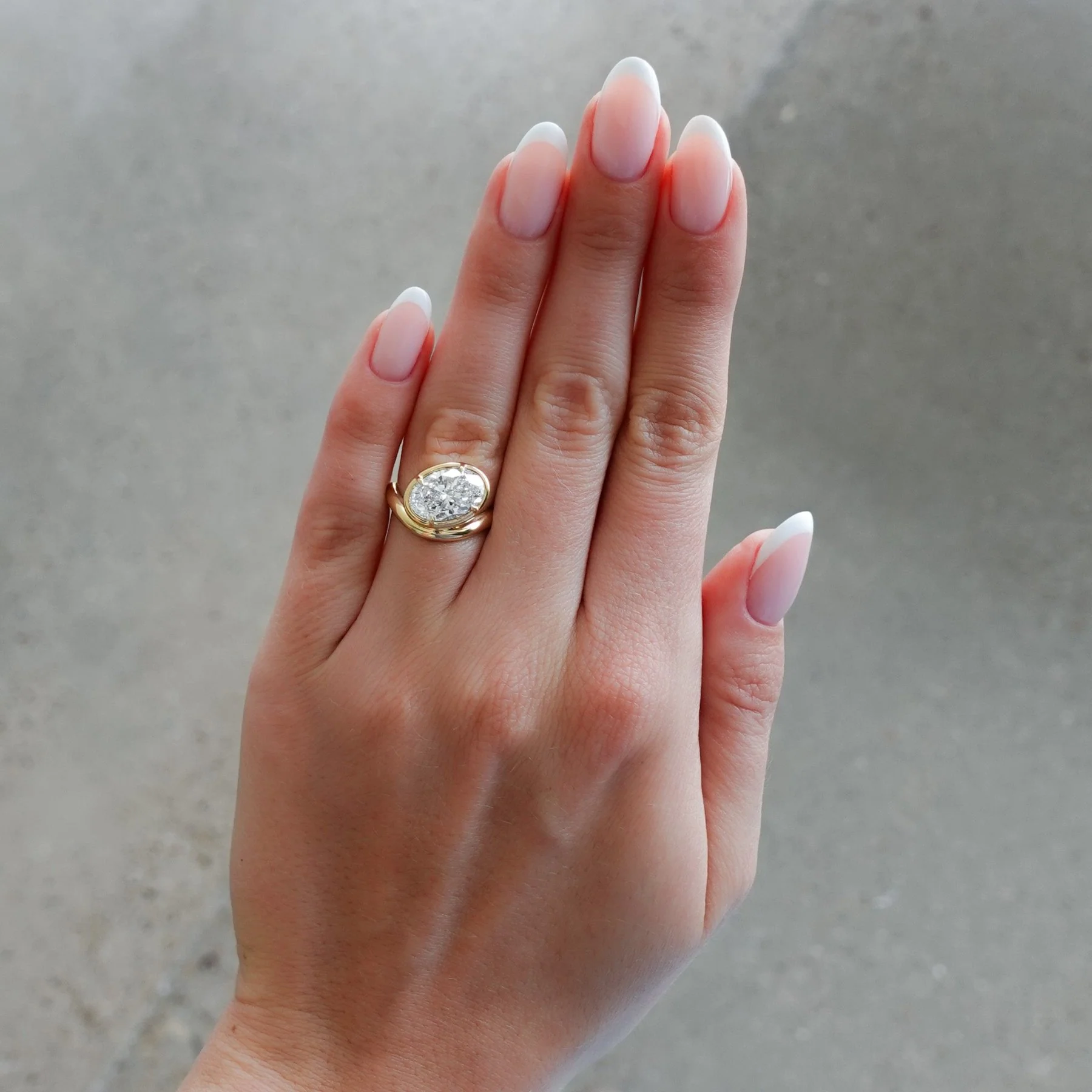 Contoured Club Engagement Ring with an Oval Cut Diamond - Image 3