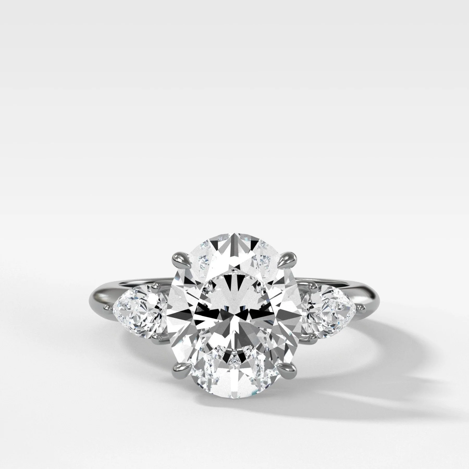Three Stone Engagement Ring With Pear Side Stones and Oval Cut Diamond - Image 4